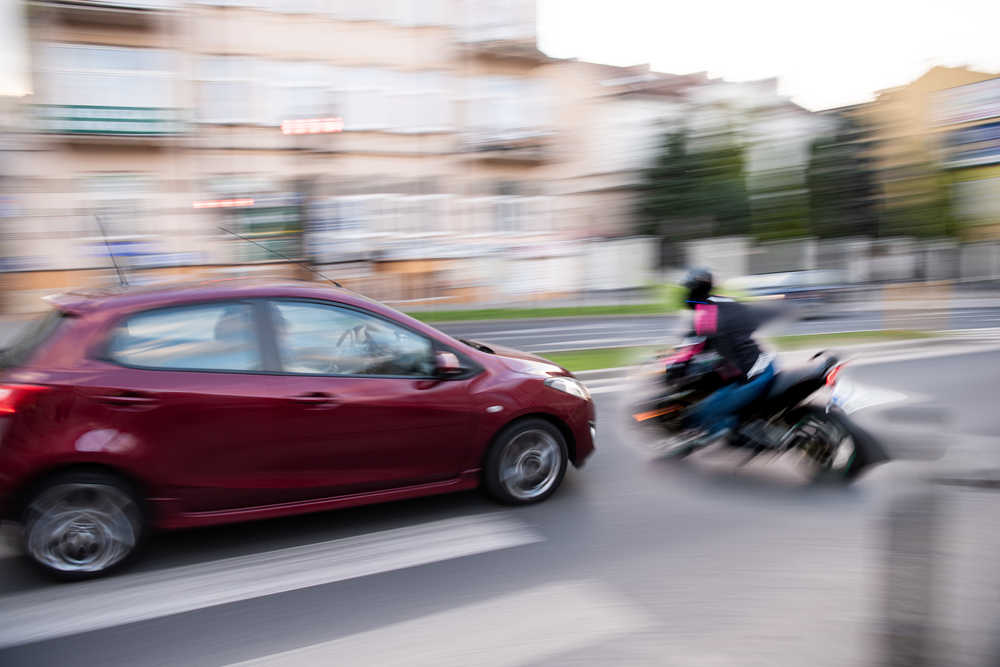Car and motorcycle collision in city intersection illustrating traffic accident and motorcycle crash scene. Car and motorcycle collision in city intersection illustrating traffic accident and motorcycle crash scene.