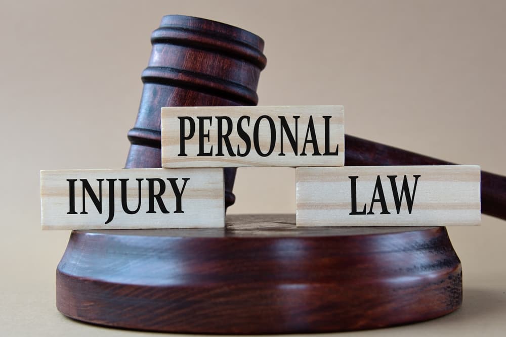 Wooden gavel and blocks reading 'Personal Injury Law'; lawsuit duration varies by case complexity and court.