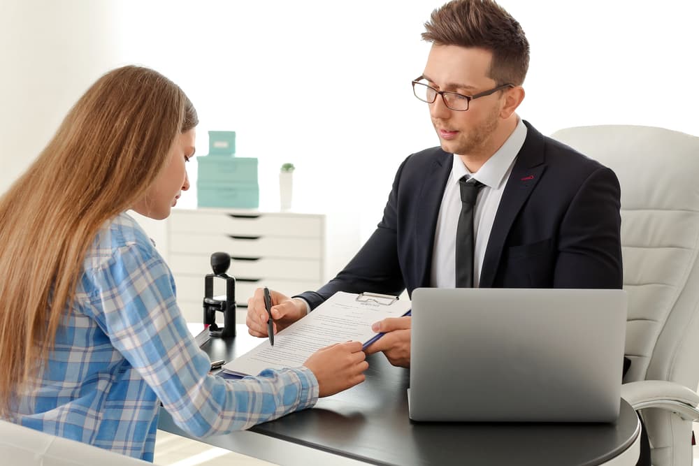 Woman in office meeting with attorney to discuss her case and legal matters.