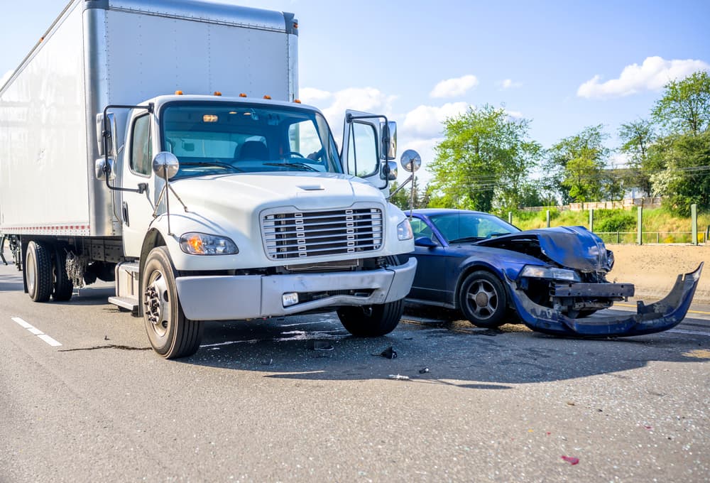 A severe truck and car collision with significant damage, illustrating the potential need for legal action.