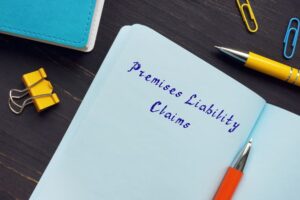 Concept of premises liability claims illustrated by sign on the page, representing legal responsibility for property conditions.