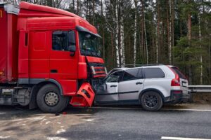 A car involved in a collision with a large truck, set against a transportation backdrop.