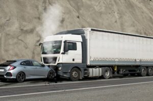 A road accident resulting from a head-on collision between a car and a truck.