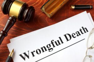A wooden surface bears a document titled "Wrongful Death," signifying the legal designation of a tragic loss due to negligence or misconduct.