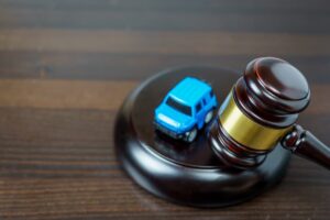 Automobile auction concept: Judge's mace on a courtroom table, symbolizing the sale of vehicles by auction or legal rights.