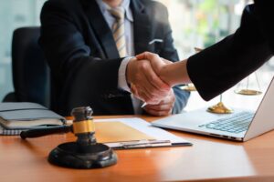 Businessman shaking hands with lawyers discussing a contract agreement. Legal advice and justice concept.