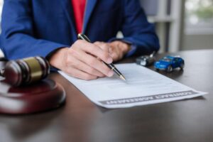 A lawyer working at a courtroom table, representing the legal aspects of car auctions and fair sales laws.
