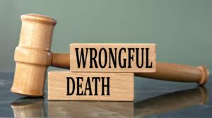 "WRONGFUL DEATH" – Wooden Blocks with a Judge's Gavel in the Background.
