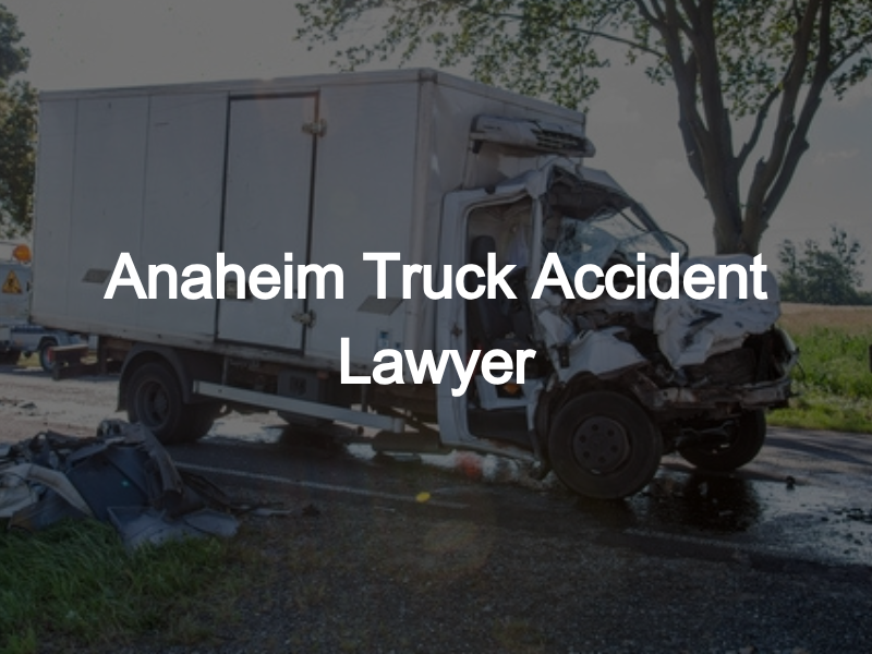 A heavily damaged white box truck sits on the roadside after a serious collision, with debris scattered around. The text overlay reads "Anaheim Truck Accident Lawyer.