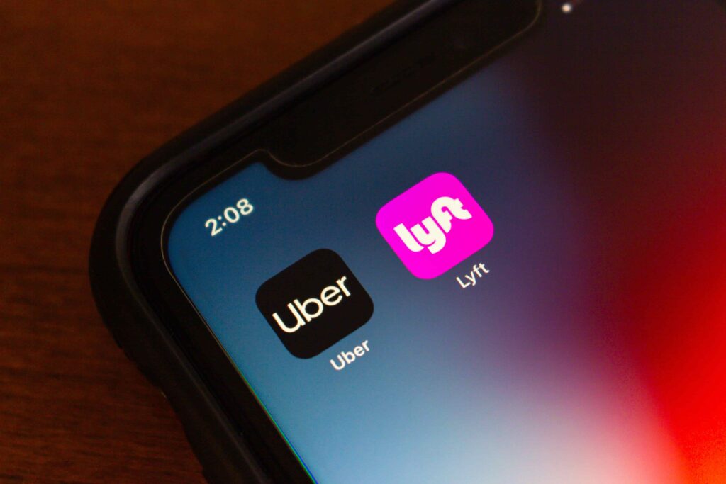 Uber and Lyft ride-sharing apps displayed on smartphone screen.